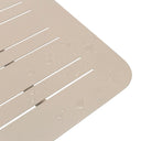 Beige textured aluminium table top with water droplets on a white background