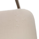 Close-up of a beige upholstered chair seat with a white background